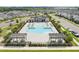 Aerial view of a community pool with lounge chairs and covered seating areas surrounded by lush landscaping at 28761 Sweet Persimmon Dr, Wesley Chapel, FL 33543