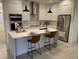 Modern kitchen with stainless steel appliances, an island, and a marble backsplash at 10153 Wildcat St, Port Charlotte, FL 33981