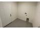 A clean, well-lit room with a door and tile flooring, perfect for versatile use at 10153 Wildcat St, Port Charlotte, FL 33981