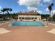 This community pool offers a refreshing retreat with ample seating and a view of the clubhouse at 3010 Grand Bay Blvd # 472, Longboat Key, FL 34228