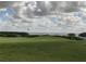 The image showcases a picturesque golf course with a stunning view of the water and sky at 3010 Grand Bay Blvd # 472, Longboat Key, FL 34228