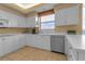 Bright kitchen features white cabinets, stainless steel appliances, and a large window at 3010 Grand Bay Blvd # 472, Longboat Key, FL 34228
