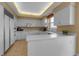 Well-lit kitchen boasts white cabinetry, modern appliances, and ample counter space for culinary creations at 3010 Grand Bay Blvd # 472, Longboat Key, FL 34228