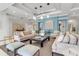 A stylish living room features modern decor, comfortable seating, and sophisticated lighting with tranquil blue accent wall at 3010 Grand Bay Blvd # 472, Longboat Key, FL 34228