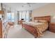Bedroom features a bed, balcony access, and office area at 3010 Grand Bay Blvd # 472, Longboat Key, FL 34228