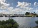 This photo showcases a vibrant marina filled with numerous boats docked on a sunny day at 3010 Grand Bay Blvd # 472, Longboat Key, FL 34228
