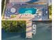 Aerial view of the outdoor living space, with pool, dock, and canal views at 328 6Th Ave, Indian Rocks Beach, FL 33785