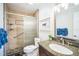 Well-lit bathroom featuring a glass shower, granite vanity, and modern fixtures at 328 6Th Ave, Indian Rocks Beach, FL 33785