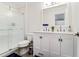 Modern bathroom with a double vanity, a sleek glass-enclosed shower and stylish lighting at 328 6Th Ave, Indian Rocks Beach, FL 33785