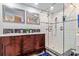 Upscale bathroom featuring a modern vanity, dual sinks, and a glass-enclosed shower at 328 6Th Ave, Indian Rocks Beach, FL 33785