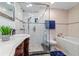 Elegant bathroom featuring a glass-enclosed shower, soaking tub, and stylish vanity at 328 6Th Ave, Indian Rocks Beach, FL 33785