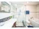 Elegant bathroom with a glass shower enclosure, soaking tub, and sleek fixtures at 328 6Th Ave, Indian Rocks Beach, FL 33785