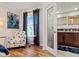 Seating area leading to the bathroom with decorative chair, window, and wood floors at 328 6Th Ave, Indian Rocks Beach, FL 33785