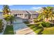 Well-maintained two-story home with an attached garage, landscaped front yard, and a paved driveway at 328 6Th Ave, Indian Rocks Beach, FL 33785