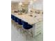Modern kitchen island featuring a granite countertop, breakfast bar, and pendant lighting at 328 6Th Ave, Indian Rocks Beach, FL 33785