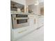 Contemporary kitchen featuring stainless steel appliances, white cabinets, and granite countertops at 328 6Th Ave, Indian Rocks Beach, FL 33785
