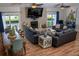 Open-concept living space with brick fireplace, modern couches, dining area, and waterfront views at 328 6Th Ave, Indian Rocks Beach, FL 33785