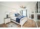 Main bedroom with ensuite bathroom featuring a ceiling fan, wood floors, and natural light at 328 6Th Ave, Indian Rocks Beach, FL 33785