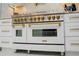 Close-up of a ZLINE white range oven with gold accents and modern design at 328 6Th Ave, Indian Rocks Beach, FL 33785