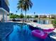 Backyard features pool, spa, outdoor furniture, and dock on the water at 328 6Th Ave, Indian Rocks Beach, FL 33785