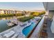 Backyard with a luxurious pool, outdoor seating, a private dock, and tranquil canal views at 328 6Th Ave, Indian Rocks Beach, FL 33785