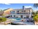 Beautiful two-story home with a backyard pool, canal access, and a waterfront patio with outdoor seating at 328 6Th Ave, Indian Rocks Beach, FL 33785