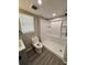 Bright bathroom with a full shower, wood-look floors, and a modern vanity at 5015 N 29Th St, Tampa, FL 33610
