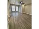 The bedroom has wood-look floors, a ceiling fan, and lots of natural light at 5015 N 29Th St, Tampa, FL 33610
