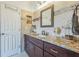 Bathroom with granite countertops, updated vanity, bronze fixtures, and ceramic tile at 6935 Runner Oak Dr, Wesley Chapel, FL 33545