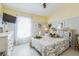 Comfortable bedroom with neutral walls, white tile, and many charming decorative touches at 6935 Runner Oak Dr, Wesley Chapel, FL 33545