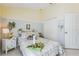 Comfortable bedroom with neutral walls, white tile, and many charming decorative touches at 6935 Runner Oak Dr, Wesley Chapel, FL 33545