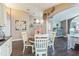 Bright dining room with butterflies, art, a round table with seating, and a built-in serving counter at 6935 Runner Oak Dr, Wesley Chapel, FL 33545