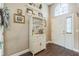 Light and airy entryway features a white cabinet, decorative accents, and a front door with sidelight at 6935 Runner Oak Dr, Wesley Chapel, FL 33545