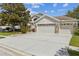 Charming single-story home featuring a three-car garage, stone accents, and well-maintained landscaping at 6935 Runner Oak Dr, Wesley Chapel, FL 33545