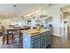 Open kitchen featuring a granite-topped island with seating, seamlessly connecting to the dining space at 6935 Runner Oak Dr, Wesley Chapel, FL 33545