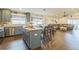 Bright kitchen with island seating flowing into dining and living areas, perfect for entertaining at 6935 Runner Oak Dr, Wesley Chapel, FL 33545
