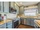Modern kitchen with stainless steel appliances, custom cabinetry, and stylish backsplash at 6935 Runner Oak Dr, Wesley Chapel, FL 33545