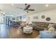 Open-concept living room flows into a modern kitchen with stainless steel appliances and ample seating space at 6935 Runner Oak Dr, Wesley Chapel, FL 33545