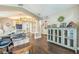 Open living room with hardwood floors, neutral paint, and lots of natural light at 6935 Runner Oak Dr, Wesley Chapel, FL 33545