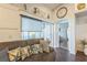 Comfortable living room showcases a couch, stylish pillows, window with shade, and decor shelves above at 6935 Runner Oak Dr, Wesley Chapel, FL 33545