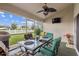Covered and screened patio with dining table and comfortable seating overlooking manicured lawn at 6935 Runner Oak Dr, Wesley Chapel, FL 33545