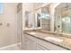 Vanity with double sinks and granite countertop in a bathroom with a walk-in shower at 924 Texas St, Englewood, FL 34223