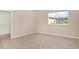A neutral toned bedroom has carpeted floors and a window providing natural light at 924 Texas St, Englewood, FL 34223