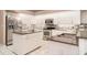 Well-equipped kitchen with stainless steel appliances, island sink, granite countertops, and white cabinets at 924 Texas St, Englewood, FL 34223