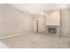 Carpeted living room with fireplace and ceiling fan at 924 Texas St, Englewood, FL 34223
