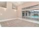 Open concept living space features tile floors, high ceilings, and sliding glass doors to the pool at 924 Texas St, Englewood, FL 34223