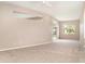An open living room features a wall of windows and sliding doors leading to the pool area at 924 Texas St, Englewood, FL 34223