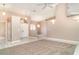 Spacious living room featuring neutral paint, tile flooring, a ceiling fan, and carpet at 924 Texas St, Englewood, FL 34223