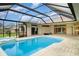 Beautiful pool with a screened enclosure and integrated spa, perfect for relaxation and outdoor enjoyment at 924 Texas St, Englewood, FL 34223