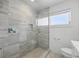 Modern bathroom features a walk-in shower, tiled walls, and updated fixtures at 3528 Casablanca Ave, St Petersburg, FL 33706